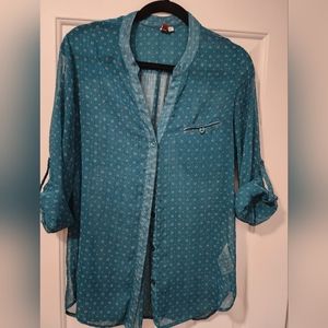 Green button-up shirt with roll-up sleeves.